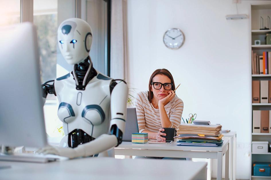 Robot Vid Dator Som Kvinna Bakom Tittar På Undrande; Ai, Undersökningar, Arbetsmarknad, Kompetens2