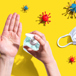 Coronavirus, Handsprit Och Skyddsmask Och Händer Mot Gul Bakgrund. Conceptbild